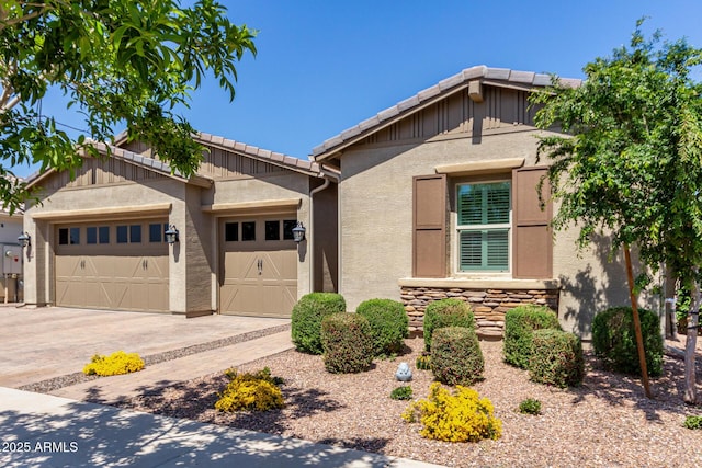 ranch-style home with stone siding, stucco siding, an attached garage, driveway, and a tile roof