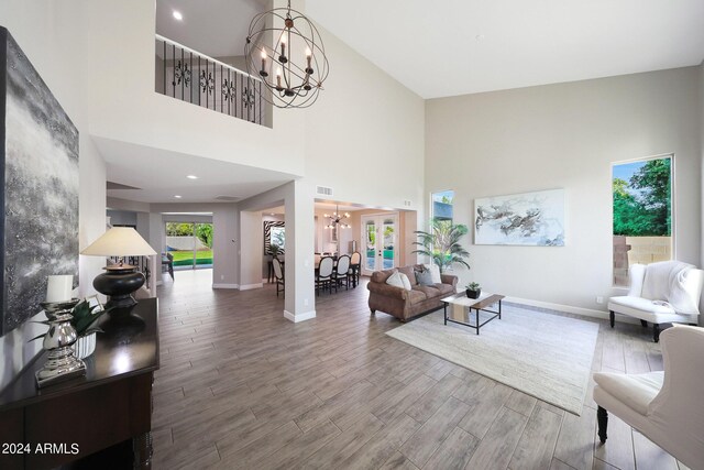 dining area featuring an inviting chandelier, a healthy amount of sunlight, and hardwood / wood-style floors