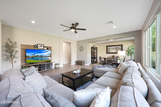 living room featuring wood-type flooring and ceiling fan