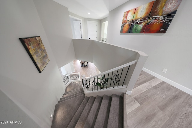 staircase with wood-type flooring