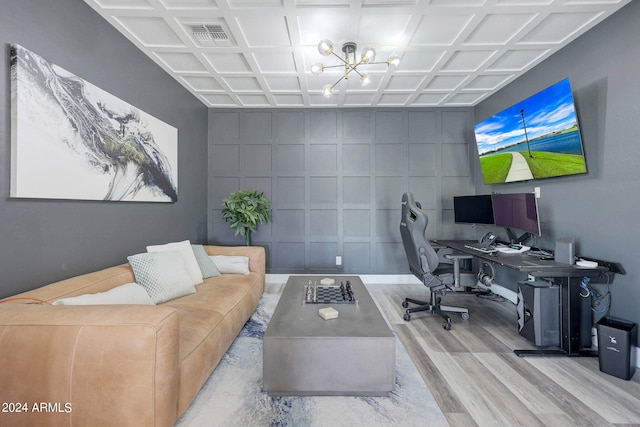 home office with coffered ceiling, a chandelier, and light hardwood / wood-style floors