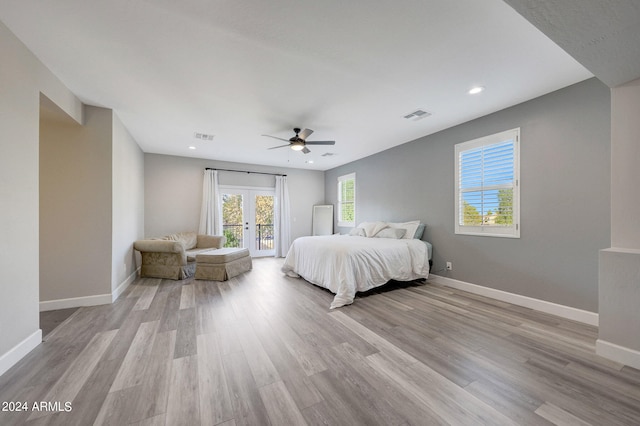 bedroom featuring light hardwood / wood-style flooring, ceiling fan, access to exterior, and french doors