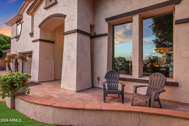 patio terrace at dusk with a garage