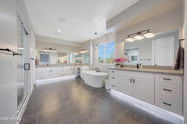 bathroom with shower with separate bathtub and vanity