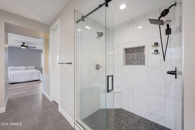 bathroom featuring ceiling fan and an enclosed shower