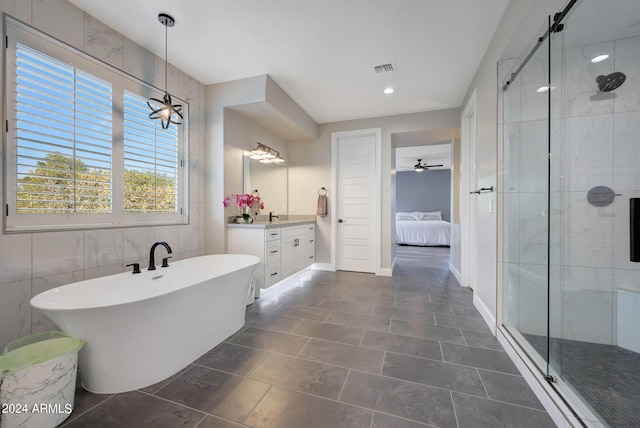 bathroom with tile walls, vanity, tile patterned flooring, separate shower and tub, and ceiling fan