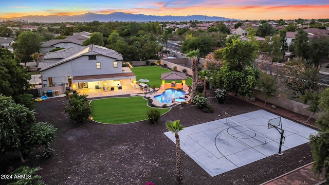 aerial view at dusk featuring a mountain view