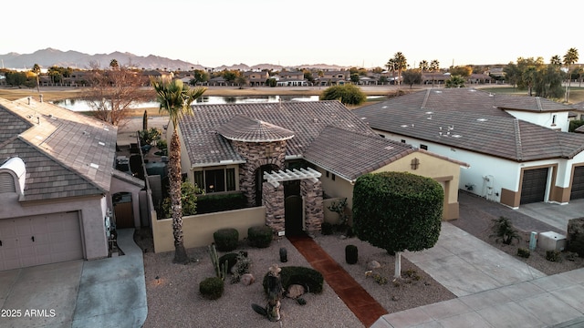 birds eye view of property with a water and mountain view