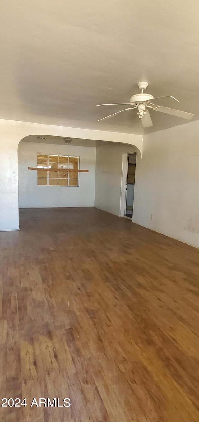 spare room featuring wood-type flooring and ceiling fan