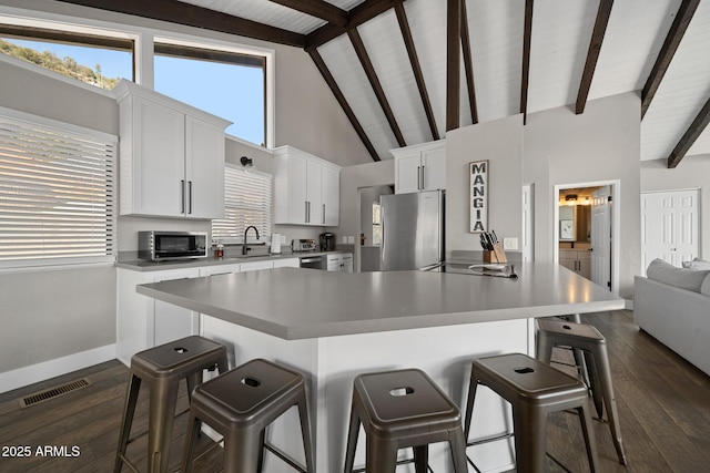 9661 W Coyote Dr, Strawberry, AZ 85544 - kitchen featuring a breakfast bar, visible vents, a sink, and appliances with stainless steel finishes