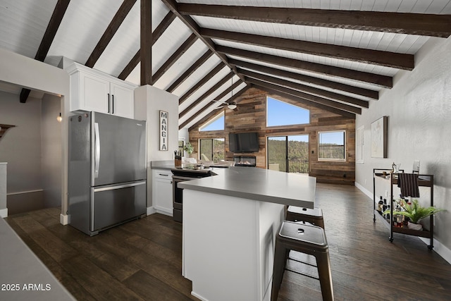 9661 W Coyote Dr, Strawberry, AZ 85544 - kitchen with a kitchen bar, a peninsula, stainless steel appliances, white cabinets, and dark wood-type flooring