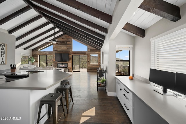 9661 W Coyote Dr, Strawberry, AZ 85544 - kitchen with dark wood-style floors, white cabinets, beamed ceiling, and a breakfast bar area