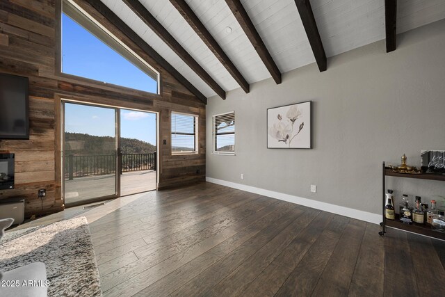 9661 W Coyote Dr, Strawberry, AZ 85544 - unfurnished living room with wood-type flooring, high vaulted ceiling, baseboards, beam ceiling, and wooden walls