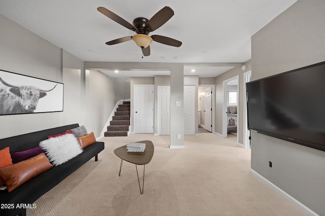 9661 W Coyote Dr, Strawberry, AZ 85544 - living area featuring light carpet, baseboards, stairway, and ceiling fan