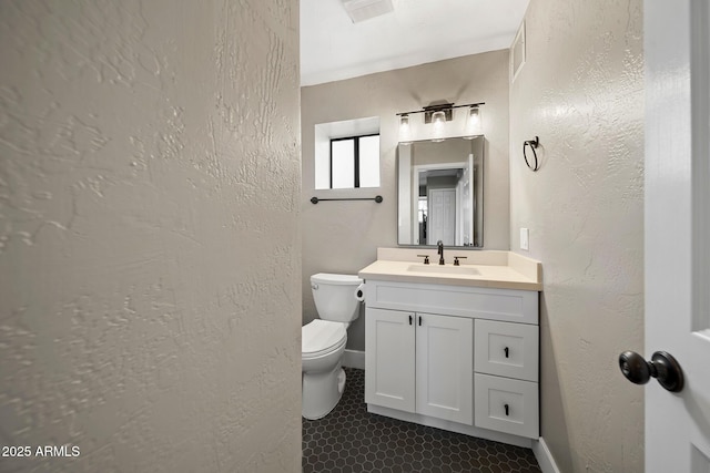9661 W Coyote Dr, Strawberry, AZ 85544 - bathroom featuring tile patterned flooring, vanity, toilet, a textured wall, and visible vents