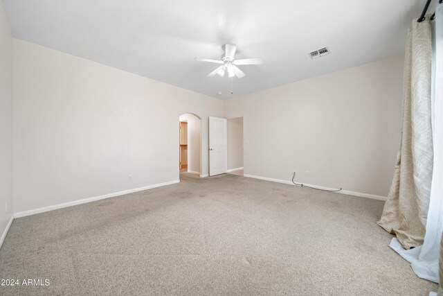 spare room with light carpet and ceiling fan