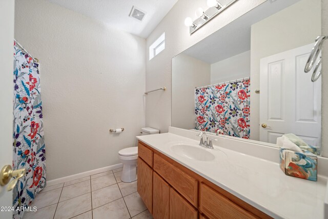 bathroom with vanity, toilet, and tile patterned floors