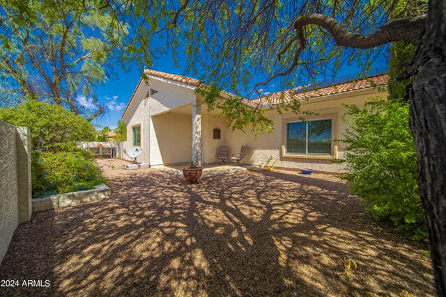 rear view of property featuring a patio area