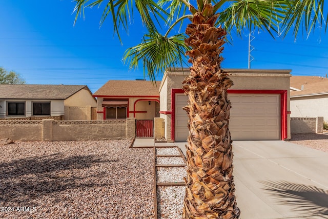 10014 N 66th Ln, Glendale, AZ 85302 - view of front of house with a fenced front yard, stucco siding, driveway, and a garage