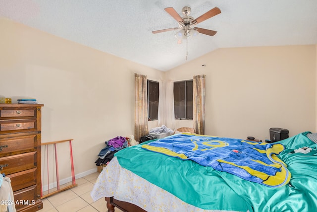 tiled bedroom featuring lofted ceiling, a textured ceiling, and ceiling fan