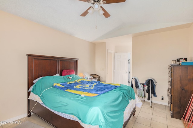 tiled bedroom featuring vaulted ceiling and ceiling fan