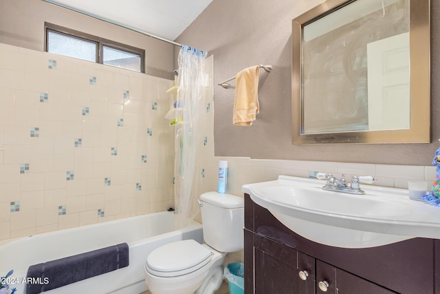 10014 N 66th Ln, Glendale, AZ 85302 - bathroom featuring tile walls, toilet, vanity, a wainscoted wall, and shower / bathtub combination with curtain
