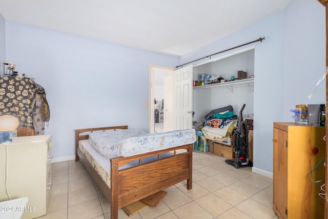 tiled bedroom with a closet