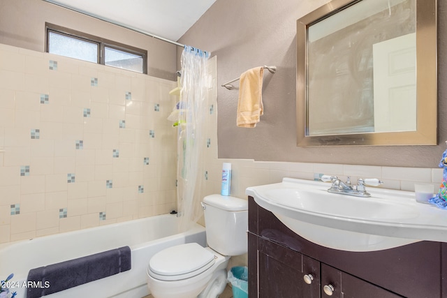 full bathroom with tile walls, vanity, shower / bath combo with shower curtain, and toilet