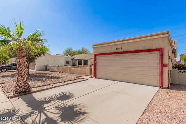10014 N 66th Ln, Glendale, AZ 85302 - view of front of house with concrete driveway, stucco siding, a garage, and fence