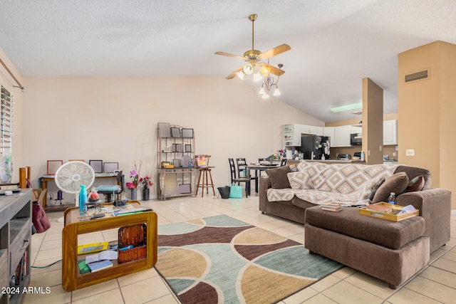 living room with ceiling fan, light tile patterned flooring, a textured ceiling, and lofted ceiling