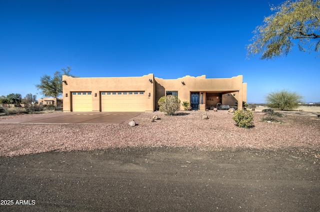 southwest-style home with a garage