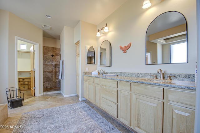 bathroom featuring vanity and a tile shower