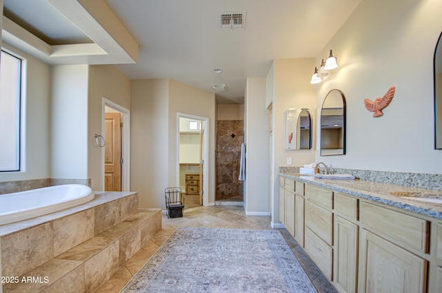 bathroom featuring vanity, plenty of natural light, and independent shower and bath