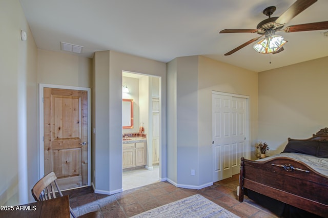 bedroom featuring ensuite bath, a closet, and ceiling fan