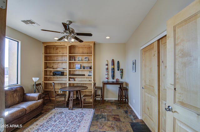 living area featuring ceiling fan