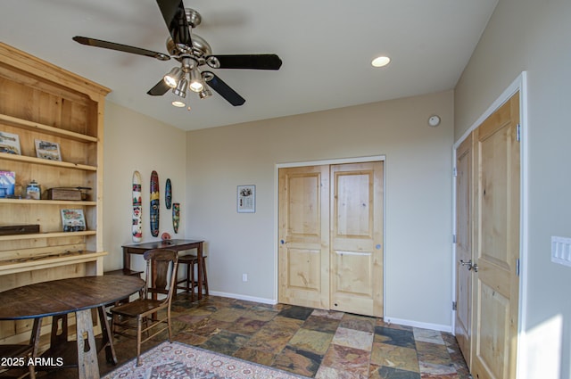 entrance foyer with ceiling fan