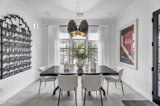 dining room with ornamental molding, visible vents, and baseboards