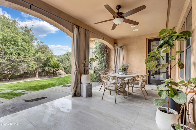 view of patio featuring ceiling fan and outdoor dining area