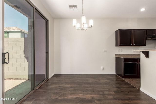 1255 S Rialto Unit 115, Mesa, AZ 85209 - unfurnished dining area with a chandelier, dark wood finished floors, and recessed lighting