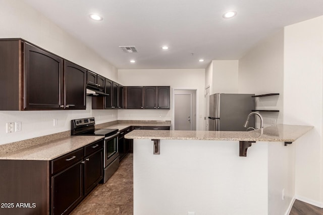 1255 S Rialto Unit 115, Mesa, AZ 85209 - kitchen featuring stainless steel appliances, a peninsula, a kitchen bar, dark brown cabinetry, and recessed lighting