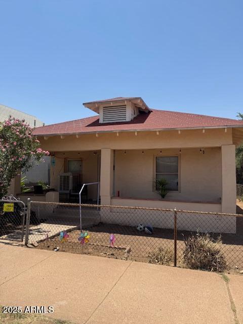 1220 N F Ave, Douglas, AZ 85607 - view of front of home with a fenced front yard and stucco siding