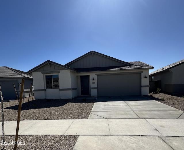 view of front of home featuring concrete driveway and an attached garage