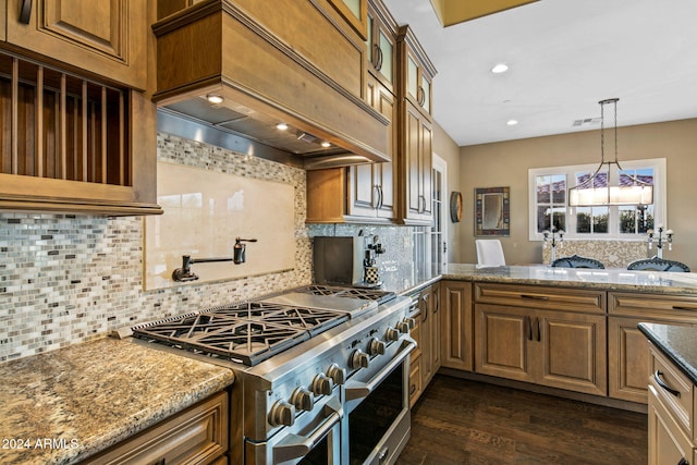 kitchen featuring dark wood-style flooring, stone countertops, premium range hood, range with two ovens, and backsplash