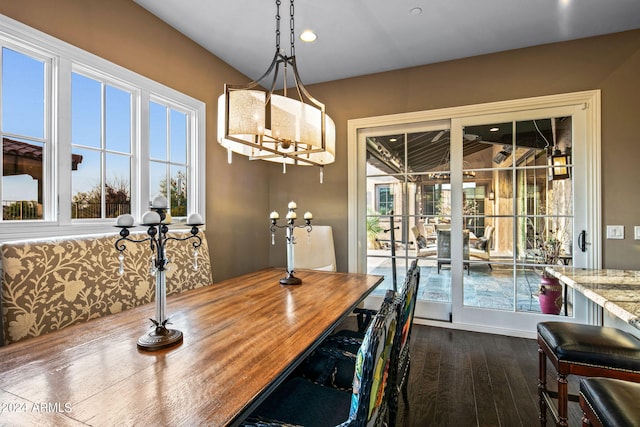 dining area with recessed lighting, dark wood finished floors, and a notable chandelier