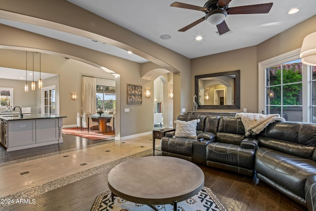 living room with recessed lighting, arched walkways, baseboards, and ceiling fan
