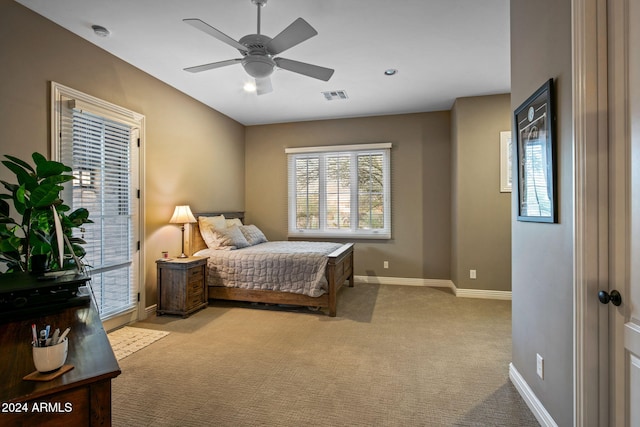 bedroom featuring visible vents, baseboards, access to outside, light colored carpet, and a ceiling fan