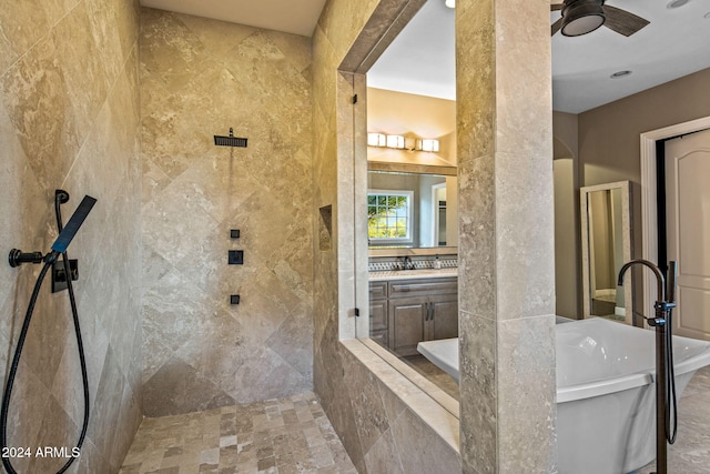 full bathroom with ceiling fan, a tile shower, a soaking tub, and vanity