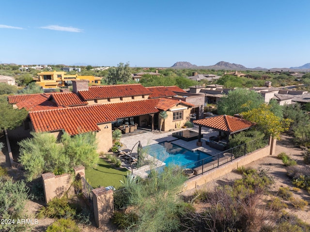pool featuring a fenced backyard, a mountain view, a gazebo, and a patio