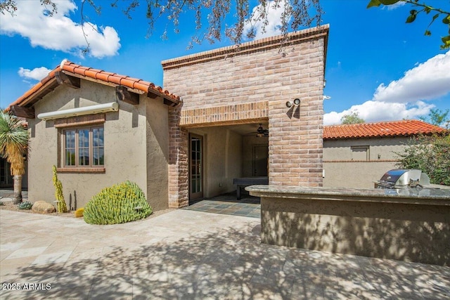37440 N 104th Pl, Scottsdale, AZ 85262 - view of front of home with exterior kitchen, a patio, stucco siding, ceiling fan, and a tile roof