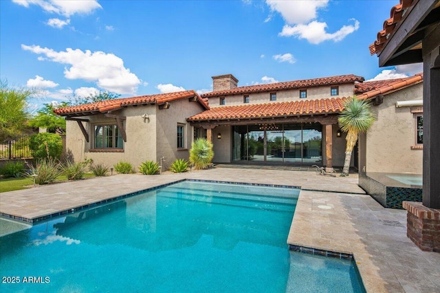 37440 N 104th Pl, Scottsdale, AZ 85262 - back of property with a tile roof, a chimney, stucco siding, and a patio area